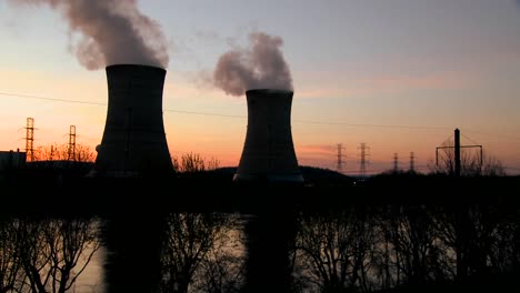 sunset behind nuclear power plant