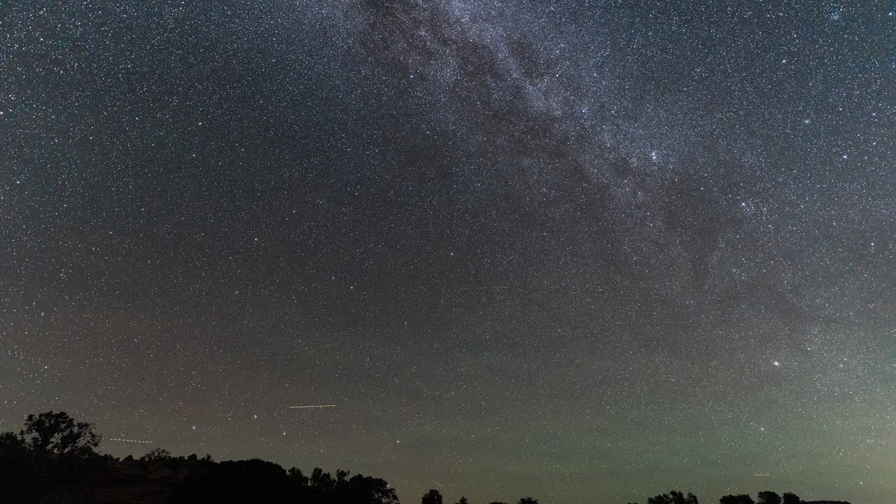 Star Trails Forming Over a Peaceful Landscape in Mesmerizing Night Sky Shot