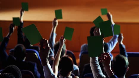 rear view of business executives show their approval by raising hands