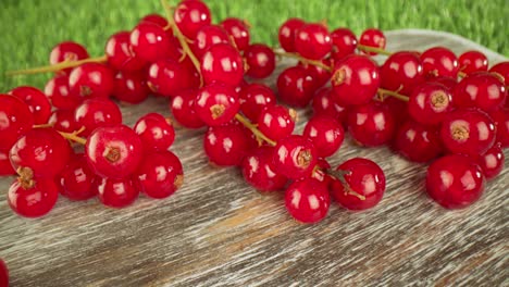 super close macro of a redcurrants on a wooden table.