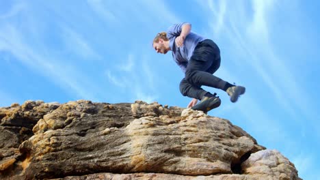 male hiker raising hands on the top of mountain 4k