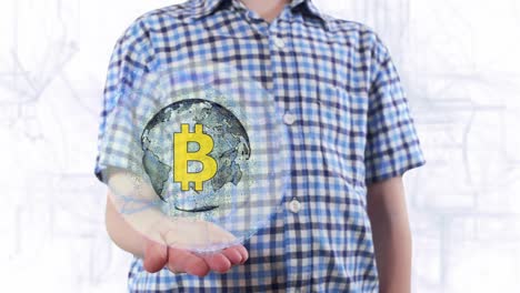 joven muestra un holograma del planeta tierra y el signo btc