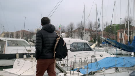 man walking along a waterfront dock