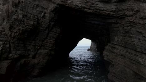 aerial fly through of an ocean cave