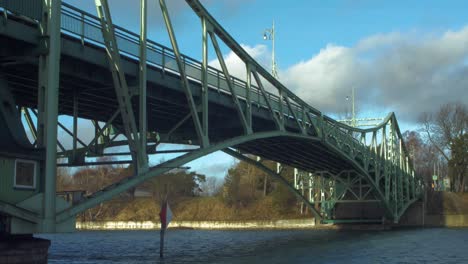 oskara kalpaka metal swing bridge at liepaja shoot from karosta canal bank in sunny afternoon, camera tilt up, wide shot