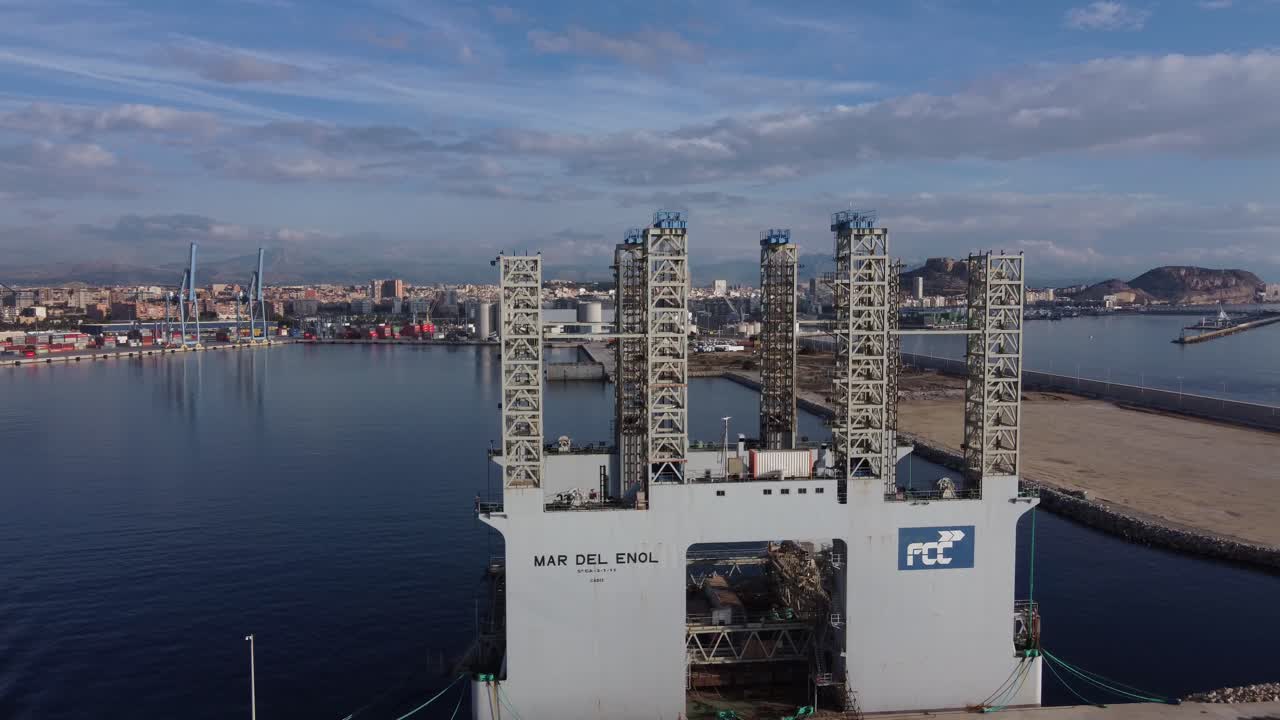 Aerial sideways view of "Mar del Enol" floating concrete factory for ports construction projects