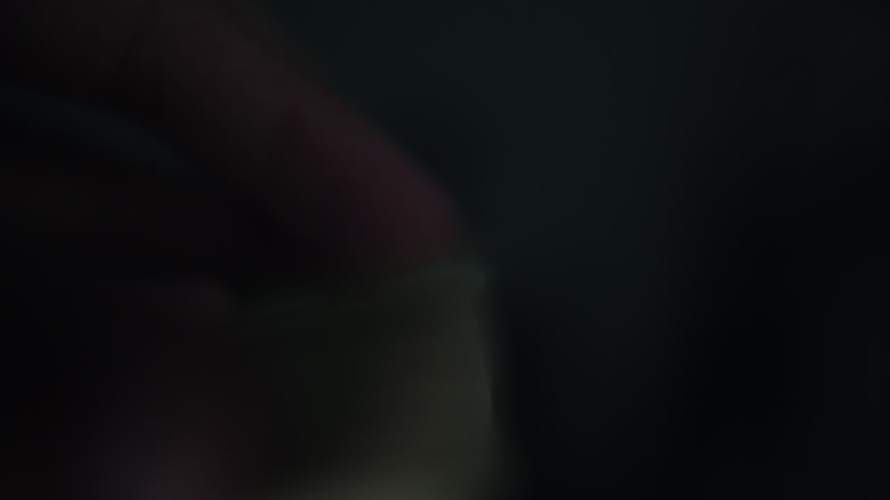 Close-up of Hands Turning Pages of a Book