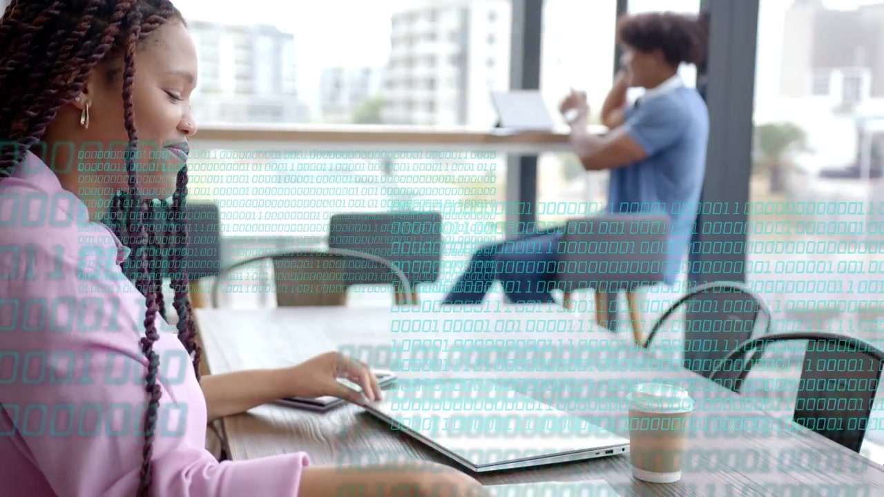 Woman opening laptop and reviewing business documents in cafe, binary overlay growing over laptop