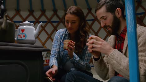 smiling young couple having tea