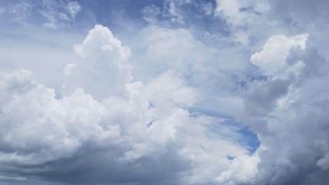 big white swirling clouds drifting across a bright blue sky over the philippines.