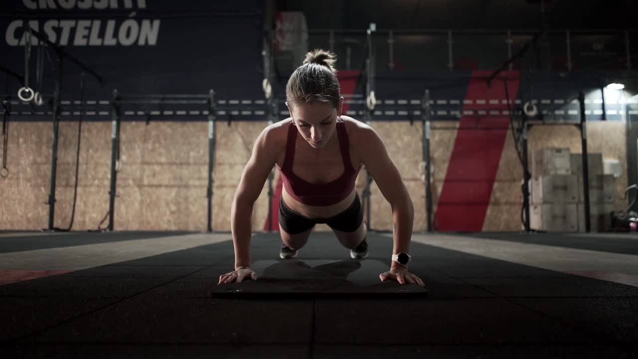 Woman doing push-ups in a gym