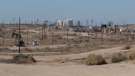 oil field with oil tanls and oil sin california, usa