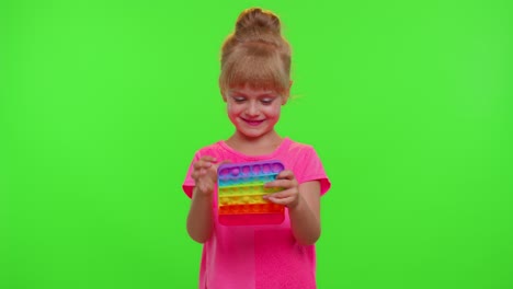 Child-girl-playing-squishy-silicone-bubbles-sensory-toy-simple-dimple-pop-it-game,-chroma-key