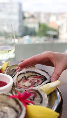 woman enjoying oysters on a platter