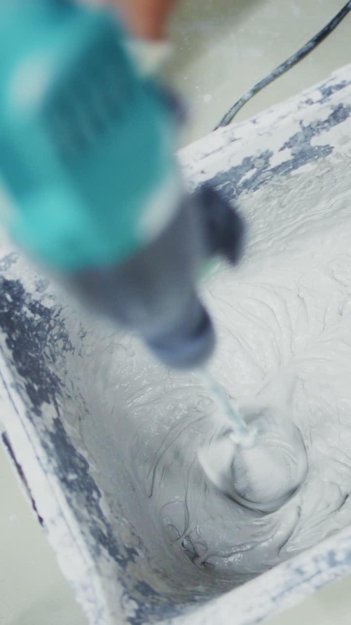 A Close-up of a Power Mixer in Action Creating Smooth Mixture in a Container, Demonstrating the Essential Process of Mixing for Various Projects and Applications
