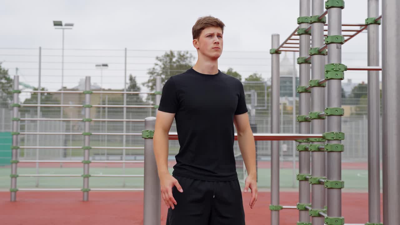Shoulder shrugs performed by young man doing dynamic stretching to warm up for workout