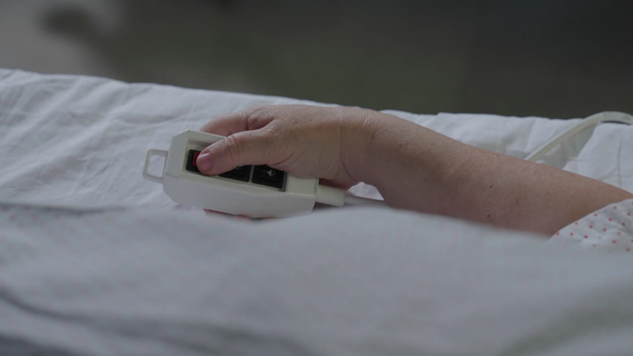 Patient using hospital bed remote control