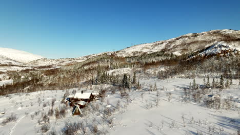 Isolated-house-in-snowy-mountain-landscape-of-Lofoten-island-in-northern-Norway-in-winter-season