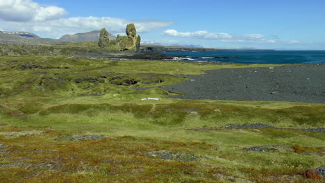 panorama of green fields and coast line around londrangar - basaltic rock formation pinnacles on snaefellsnes peninsula, iceland view from malaririf