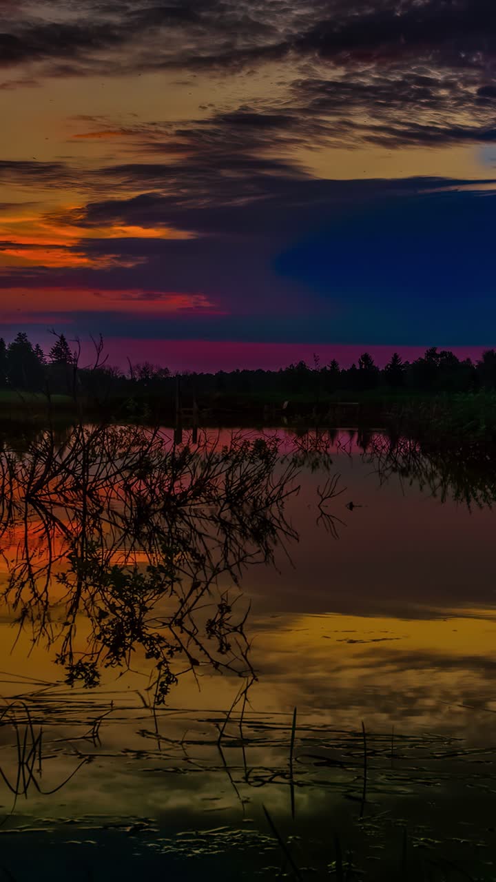 Vivid sunset over peaceful lake, vibrant colors, serene natural beauty