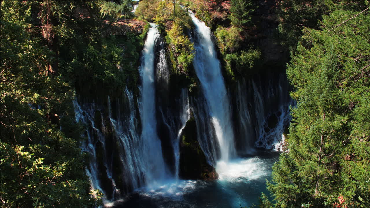 Looking down at majestic waterfalls through trees at Burney Falls California