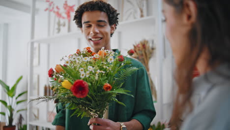 romantic boyfriend shop flowers bouquet in shopping mall floristry store.
