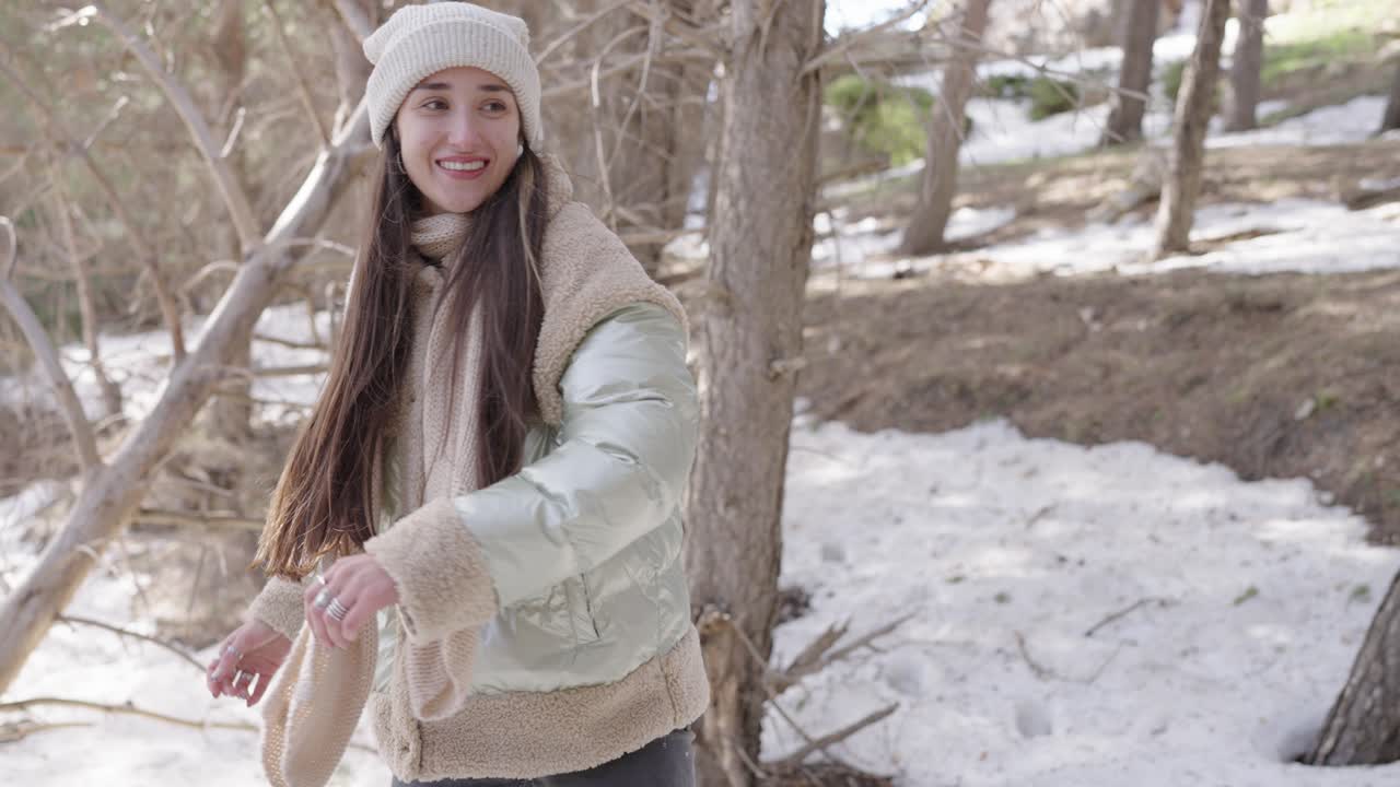 Woman enjoying winter in the forest