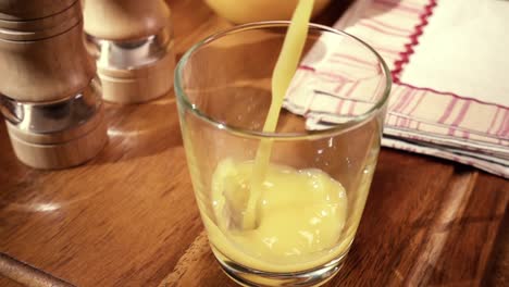 orange juice pouring into a glass, the morning breakfast. slow motion with rotation tracking shot.