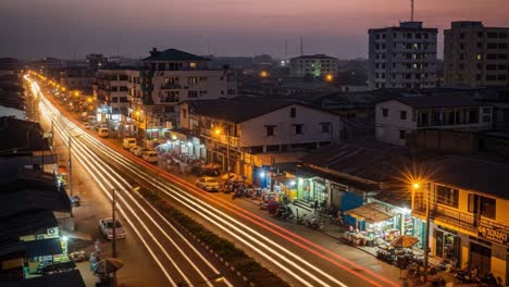 vibrant city street at night with streaking light trails