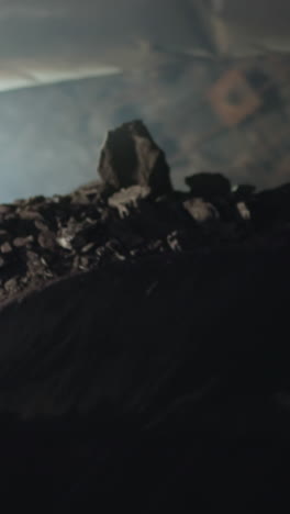 mining machinery extracts and transports ore in dark mine illuminating area with bright lights. heavy vehicle mines minerals with big dipper closeup