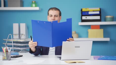 cheerful businessman working on files.