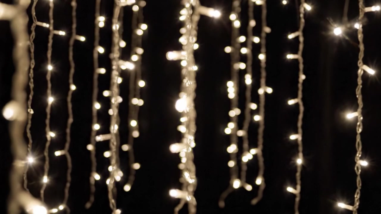 Captivating Display of Twinkling Lights Hanging in the Dark, Creating a Magical and Enchanting Ambiance for Any Festive Occasion or Celebration