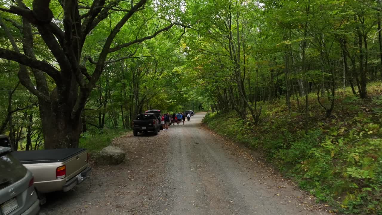 Tourist car parking at Cole Mountain during sunny day. Dolly forward shot. Virginia, USA.