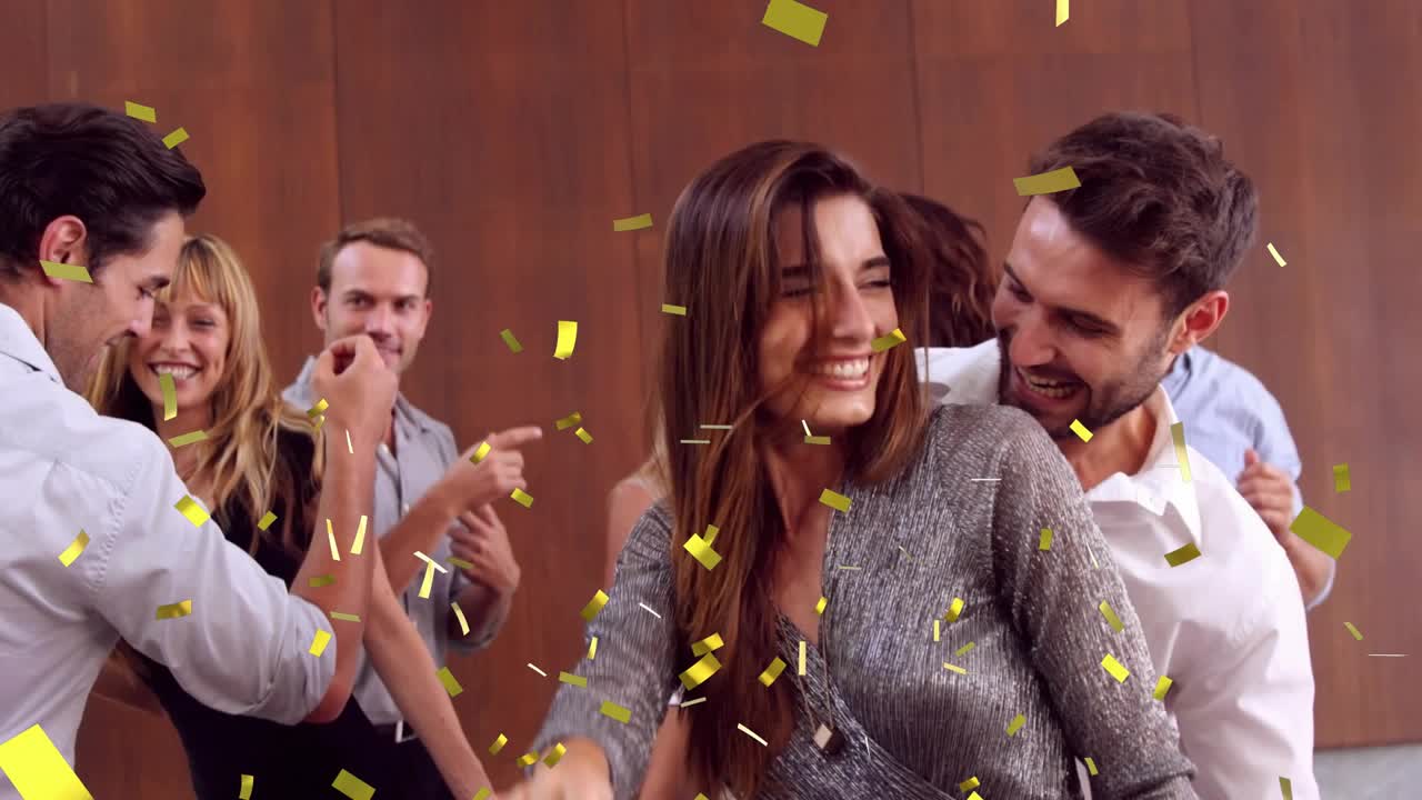 Female guest dancing with male partner as confetti falling and landing, celebrating event