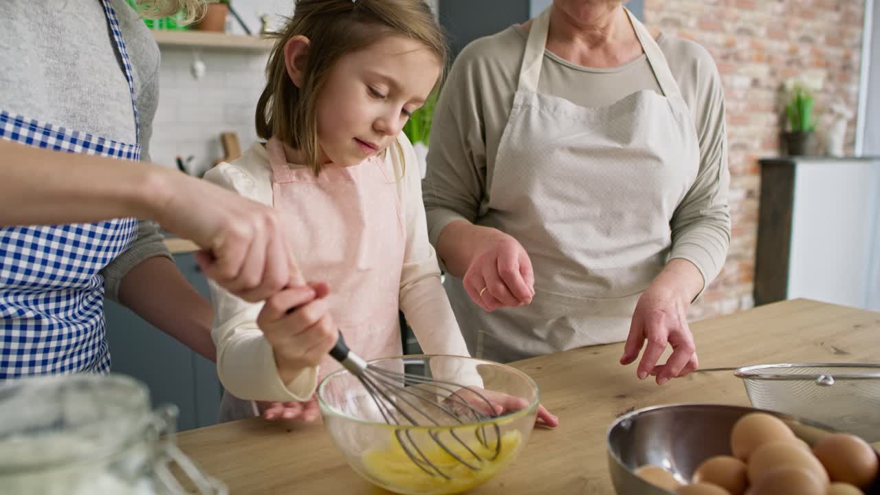 Handheld video of girl helping in the kitchen
