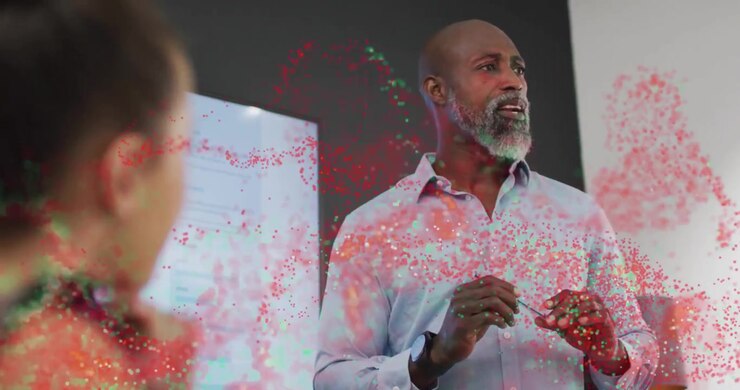 Presenter raising hands in office, explaining tech concept with swirling red green particle ribbons