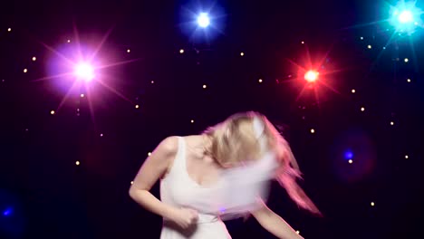 woman dancing on stage with colorful lights