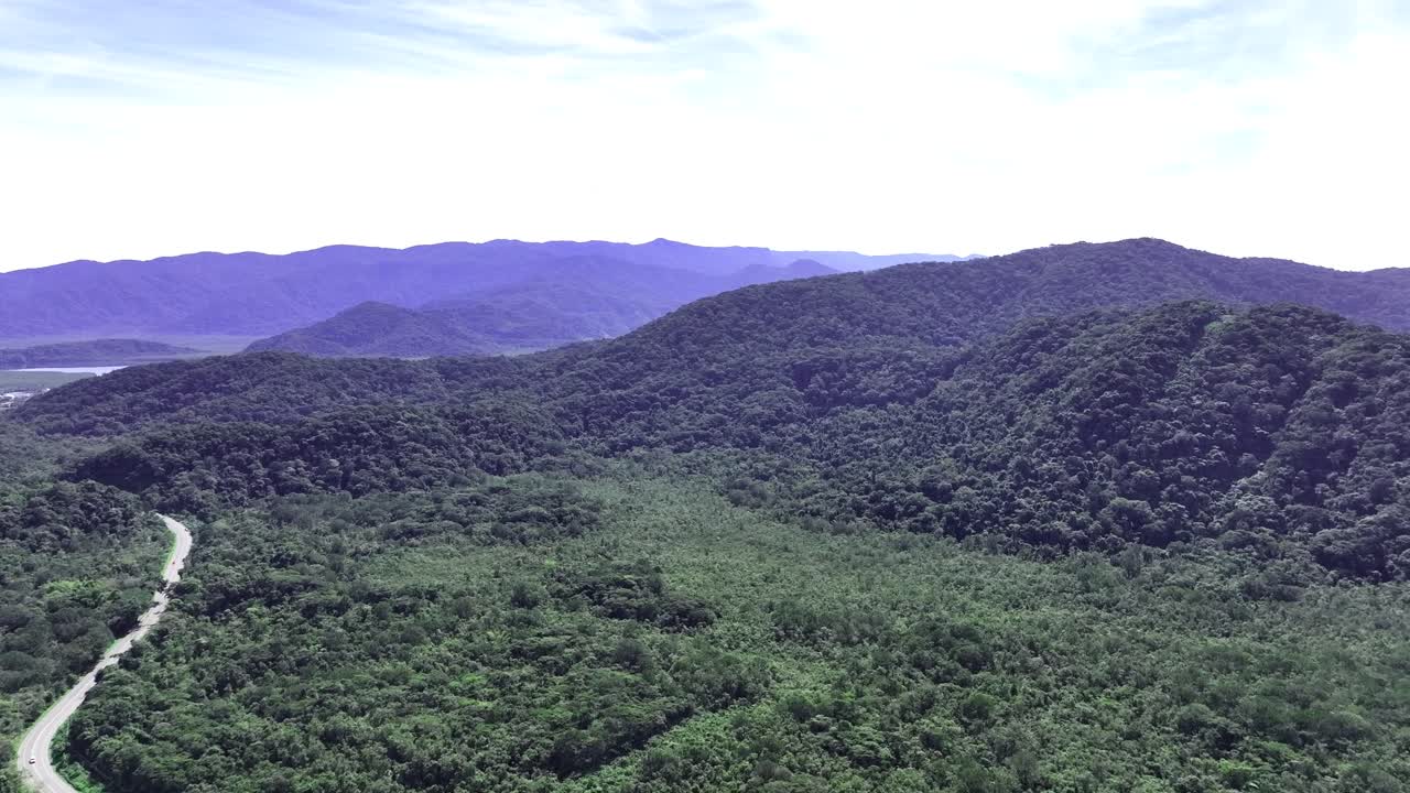A stunning aerial view of Guarujá, São Paulo, featuring the lush tropical rainforest and the iconic Bertioga Channel, showcasing Brazil's untouched natural beauty.