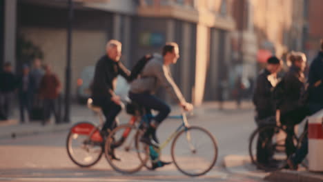 Anonymous-crowd-of-people-walking-cycling-bicycles-commuters-London-City-street-slow-motion