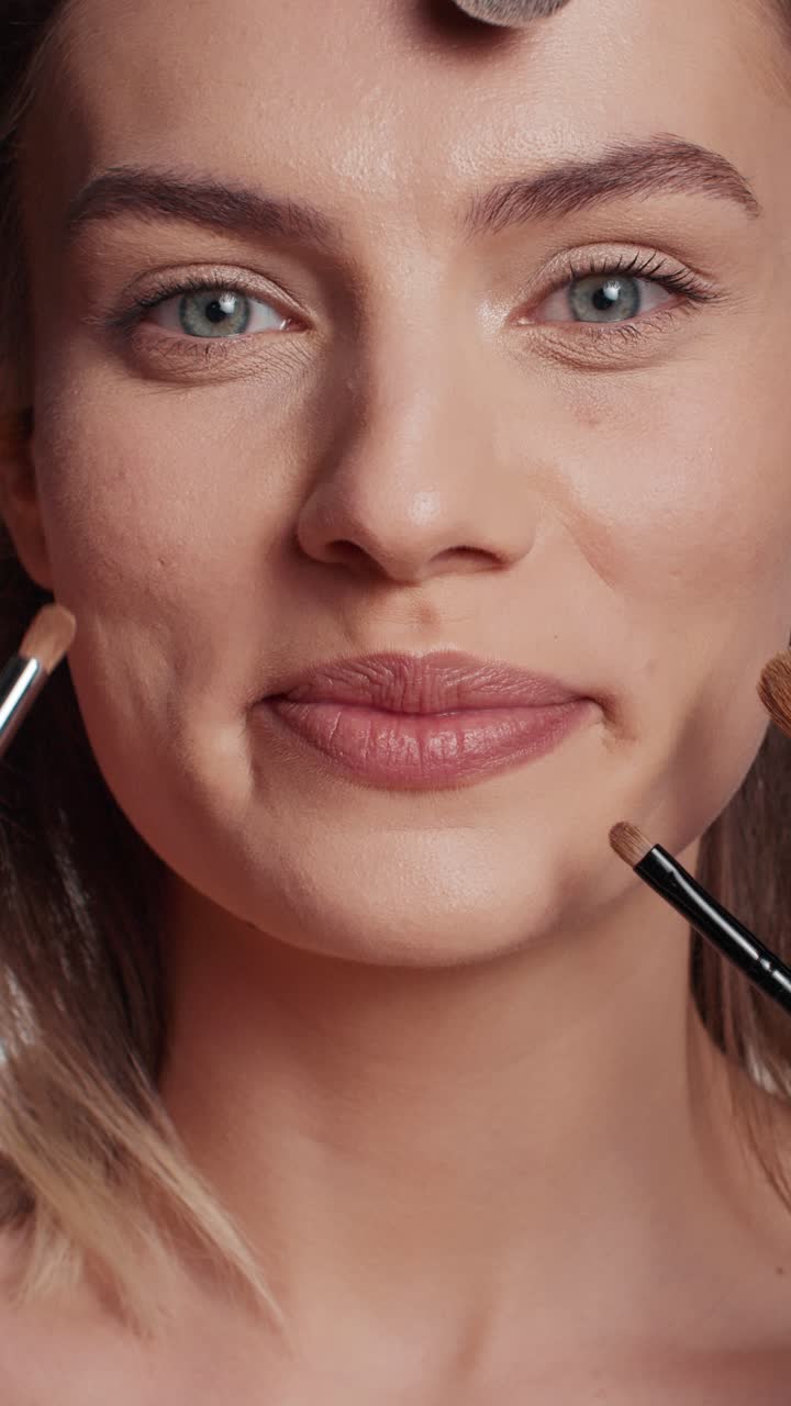 Vertical video: Team of make up artists doing makeover on beauty model