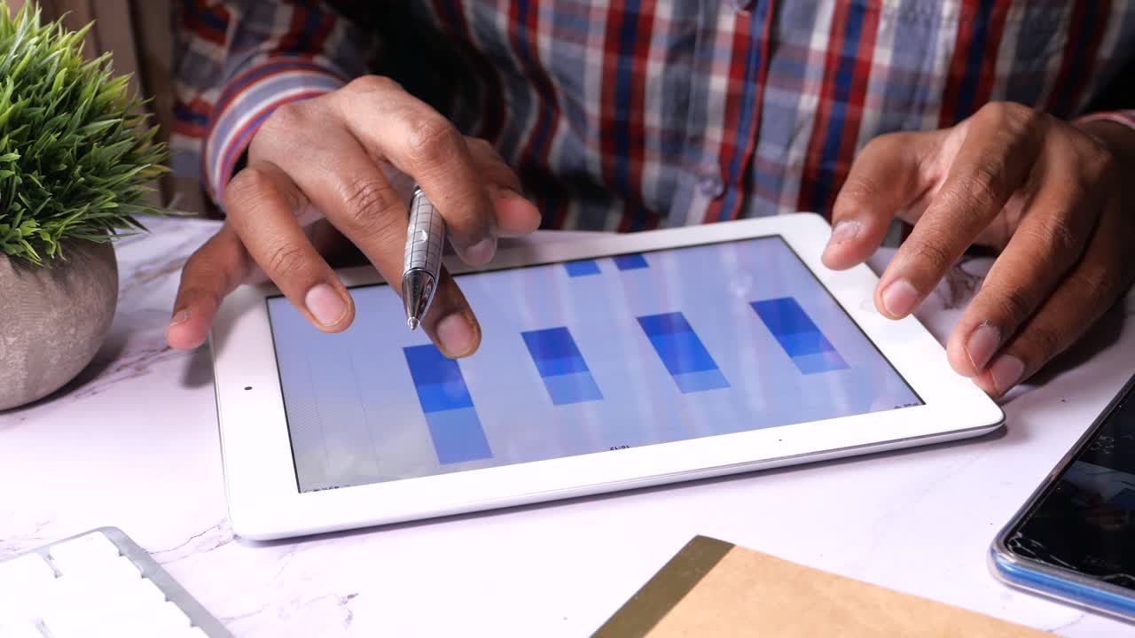 Person analyzing data on a tablet