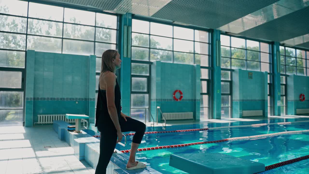 Woman at an indoor swimming pool