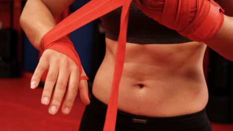 female boxer wearing red strap on wrist