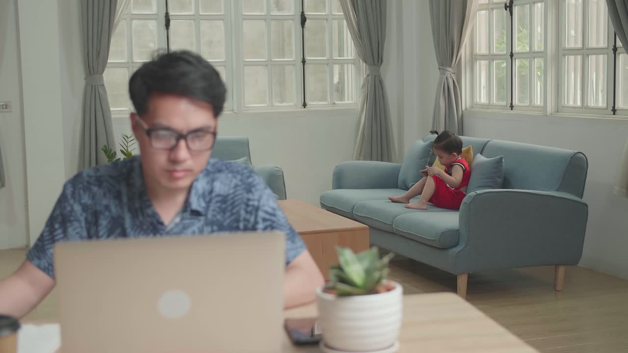 Son Use Mobile Phone And Man Working With Laptop Computer, Video In 4K