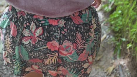 girl in flower walking through hiking trail in slow motion