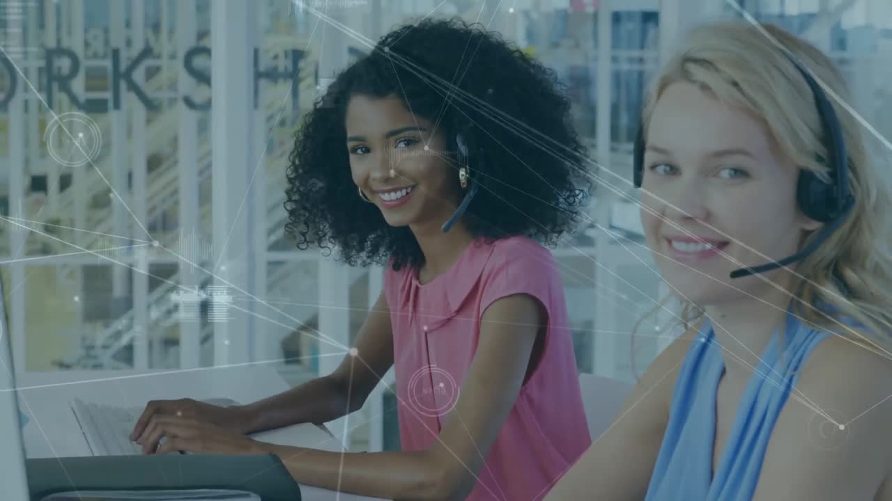 Network of connections against two diverse female office colleagues using phone headset at office