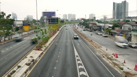 Hyperlapse-of-motorists-on-three-lane-roads-and-a-two-lane-local-road-on-both-sides-of-the-traffic