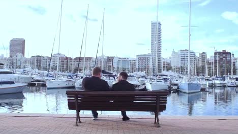 men relaxing at waterfront marina