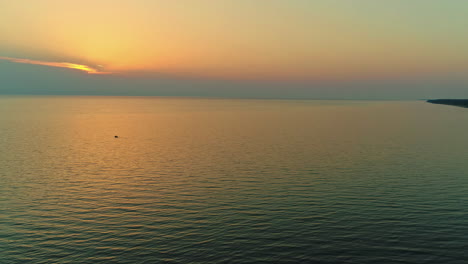 aerial view of calm waters near the seashore during the twilight