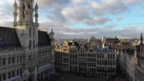 Aerial-Flying-towards-town-hall-and-Grand-Place-square-on-sunny-and-cloudy-day-of-January-in-Brussels,-Belgium